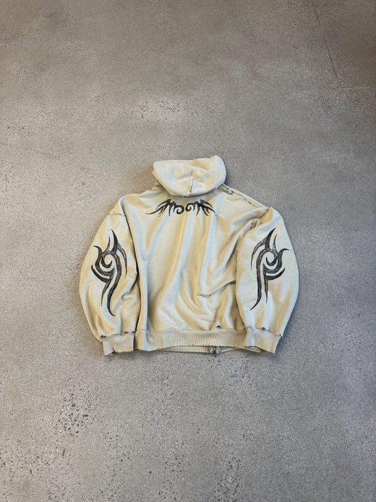 Back of Balenciaga cream tribal zipup hoodie with black tribal tattoo print across shoulders and sleeves