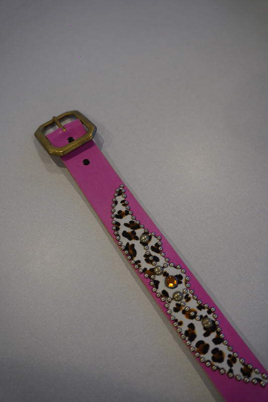 Vintage pink studded leather belt buckle detail, silver pyramid studs on animal print strap