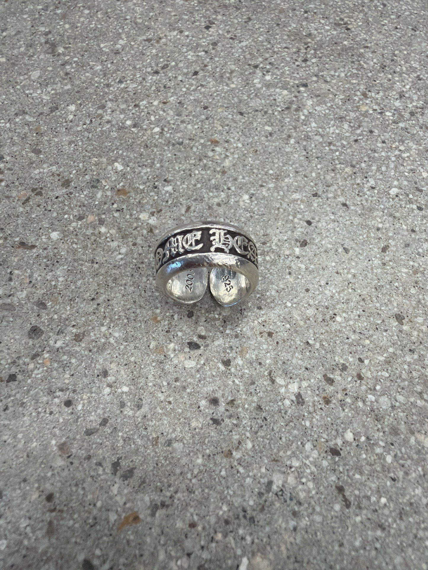 Chrome Hearts sterling silver scroll label ring profile showing oxidized scroll engraving.