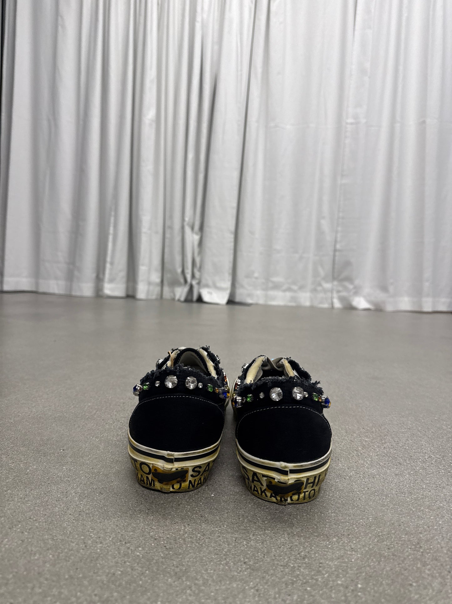 Satoshi Nakamoto Vans Era, heel view of black suede counter and printed text along midsole stripe