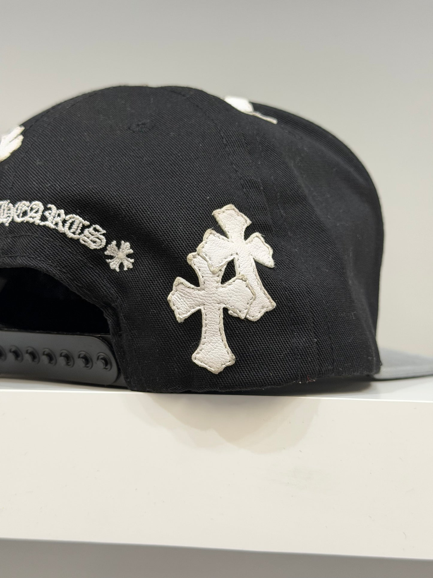 Chrome Hearts CH cross patch baseball hat back view, adjustable strap closure on gray cap
