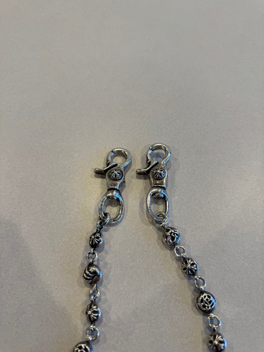 Chrome Hearts wallet chain close-up of double lobster clasp ends and engraved silver cross ball links
