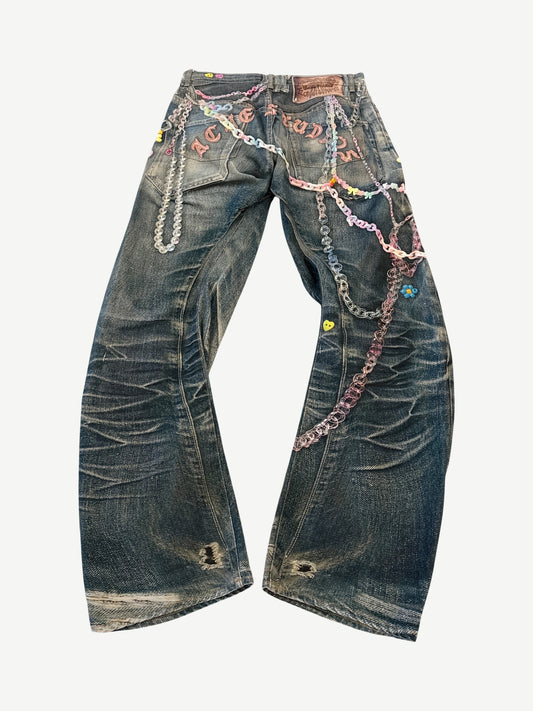 Back view of Acne Studios 1981 trompe l'oeil keychain jeans with rear leather patch and printed chain and pearl motifs