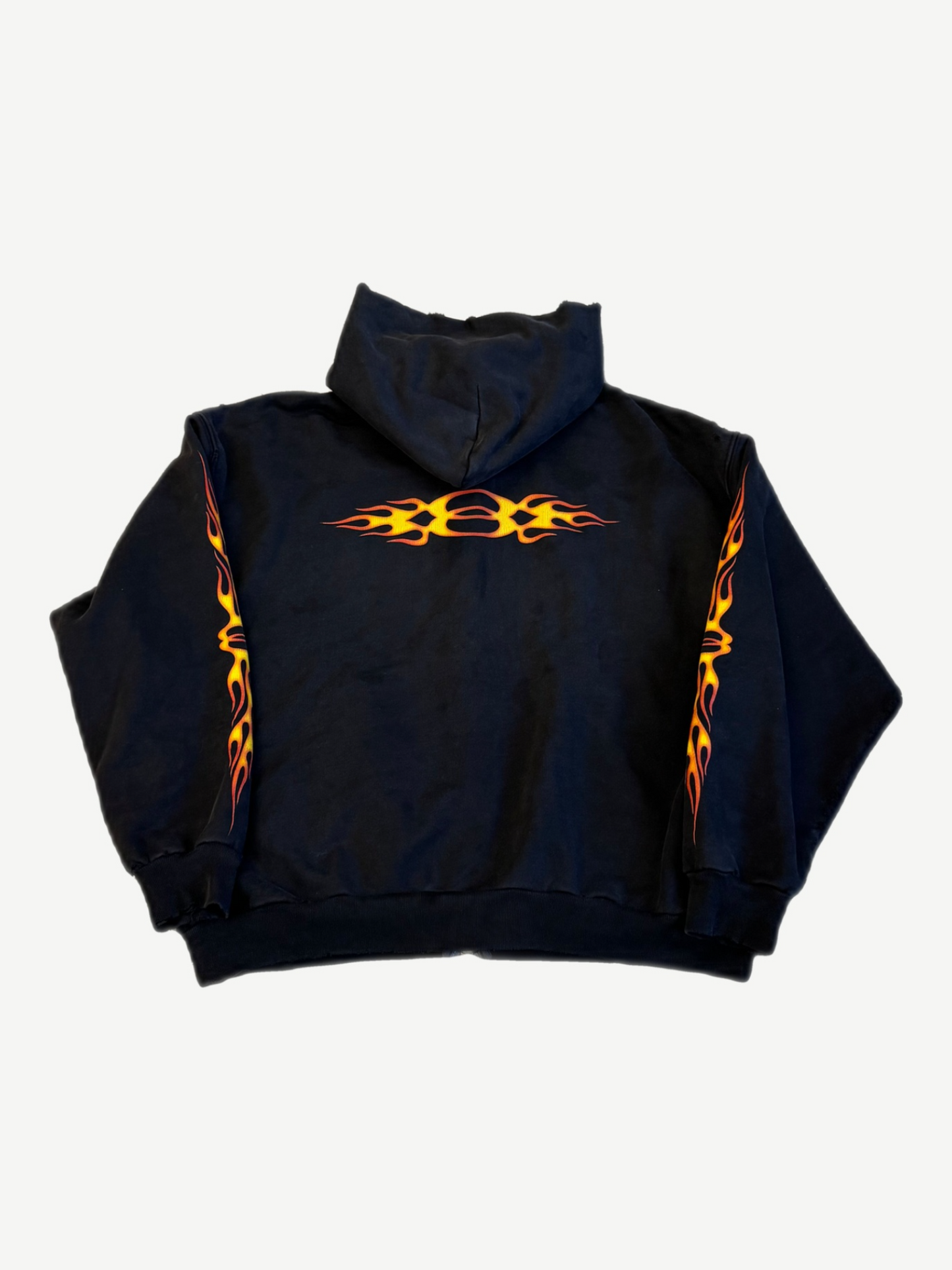 Balenciaga black Unity flame zip hoodie back, orange tribal flame graphic across upper back and sleeves.