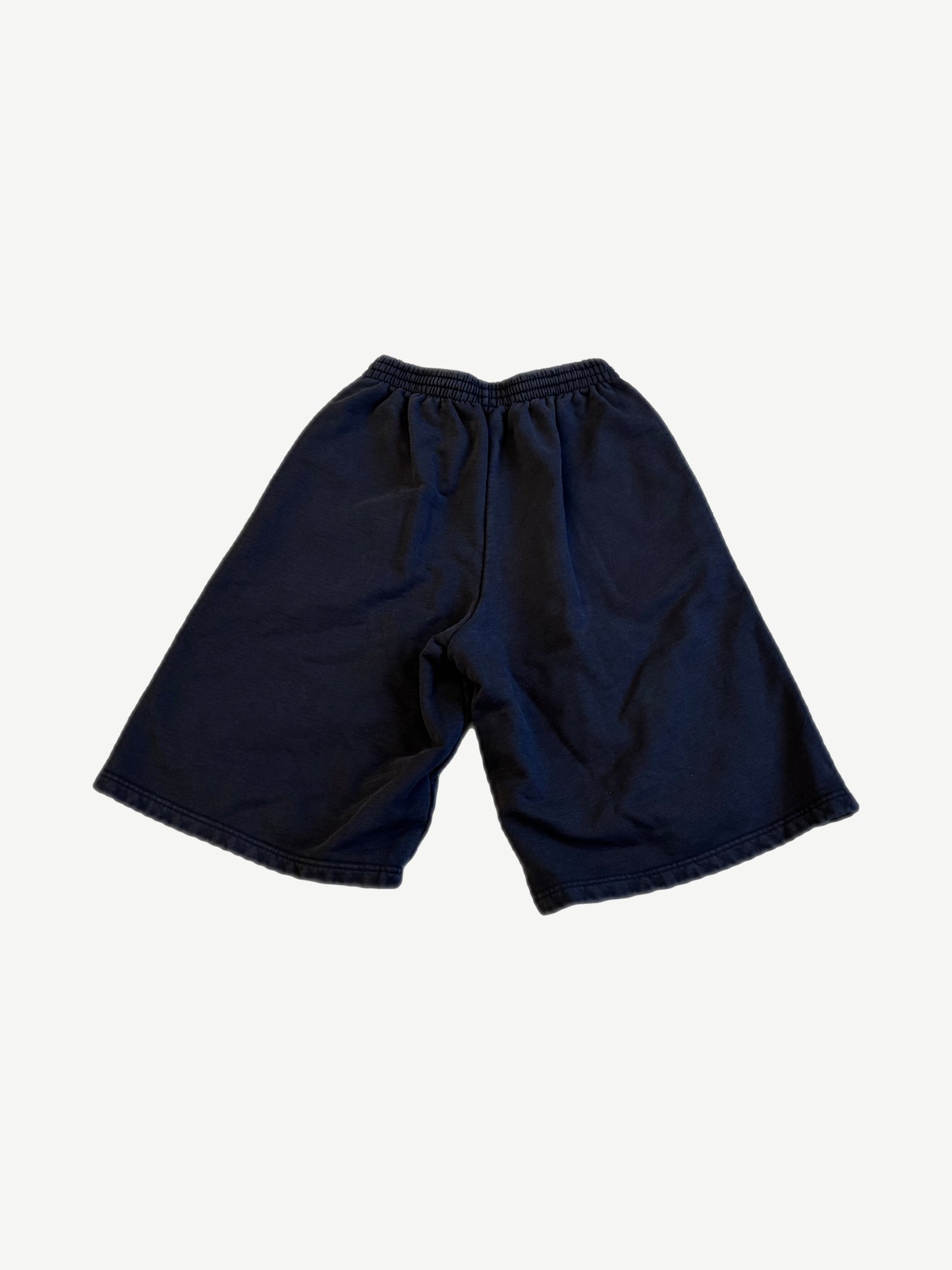 Back of Balenciaga Under Armour navy sweat shorts with elastic drawstring waist and plain knee-length cut.