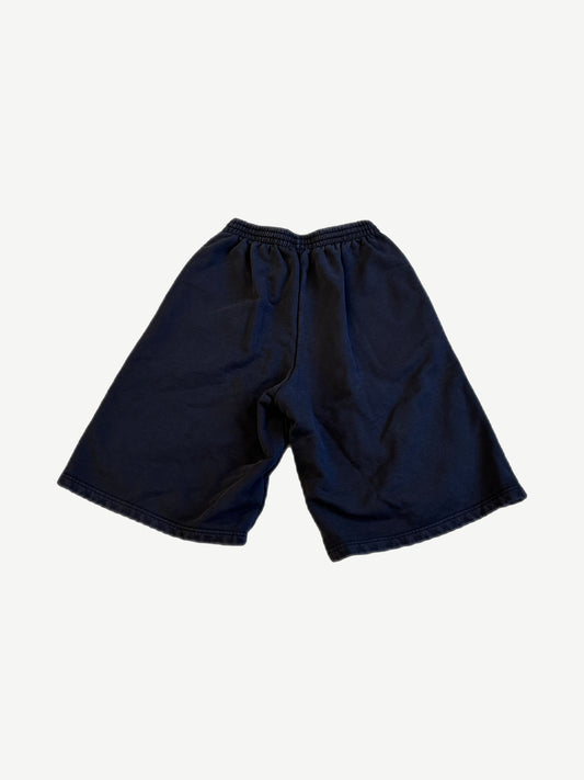 Back of Balenciaga Under Armour navy sweat shorts with elastic drawstring waist and plain knee-length cut.