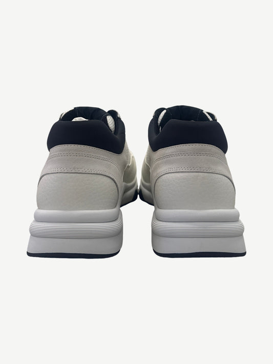 Chanel low top trainer back heel view showing black neoprene collar and white tumbled leather panel