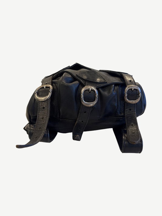 Chrome Hearts black Gunslinger leather backpack side angle with adjustable straps and cross hardware accents