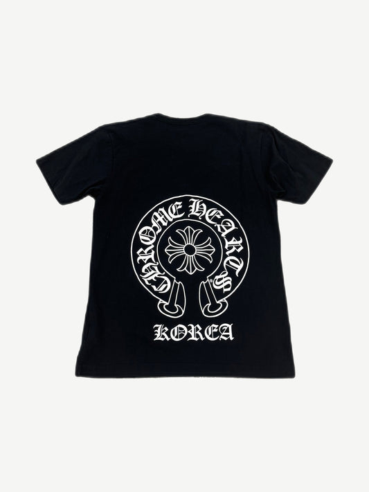 Back of Chrome Hearts black tee with large white horseshoe cross logo and Korea gothic text