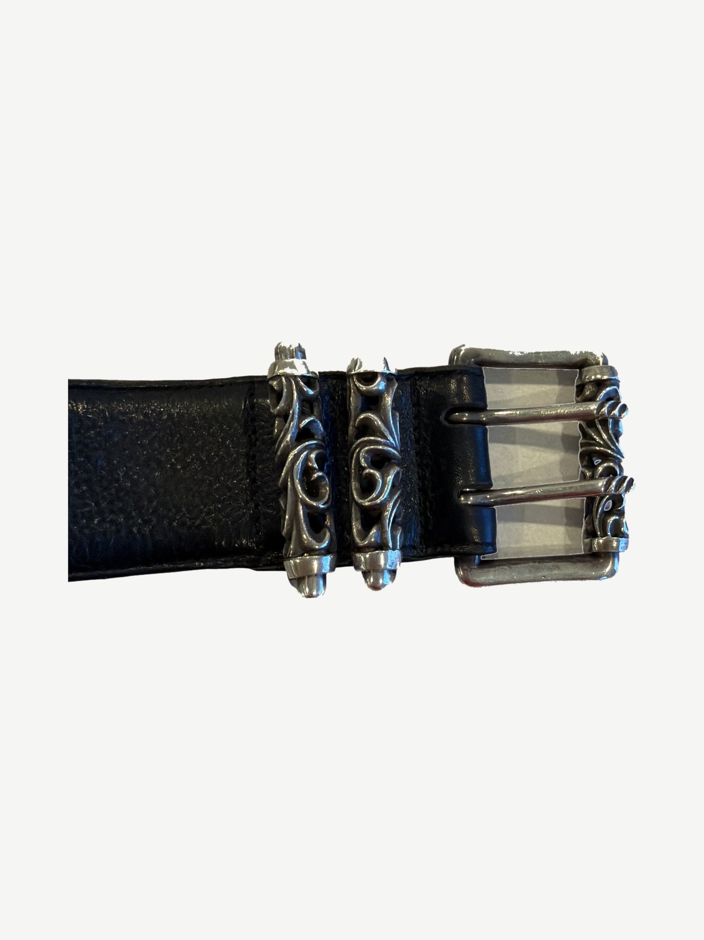 Chrome Hearts Celtic double pin roller belt buckle close-up with sterling silver scroll fleur and twin prongs