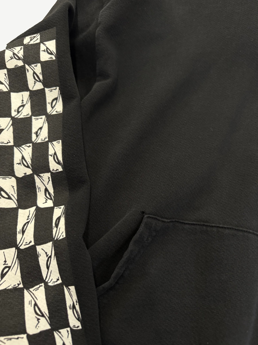 Chrome Hearts Matty Boy 99 Eyes hoodie detail, sleeve checkered eye motif and front kangaroo pocket close-up.