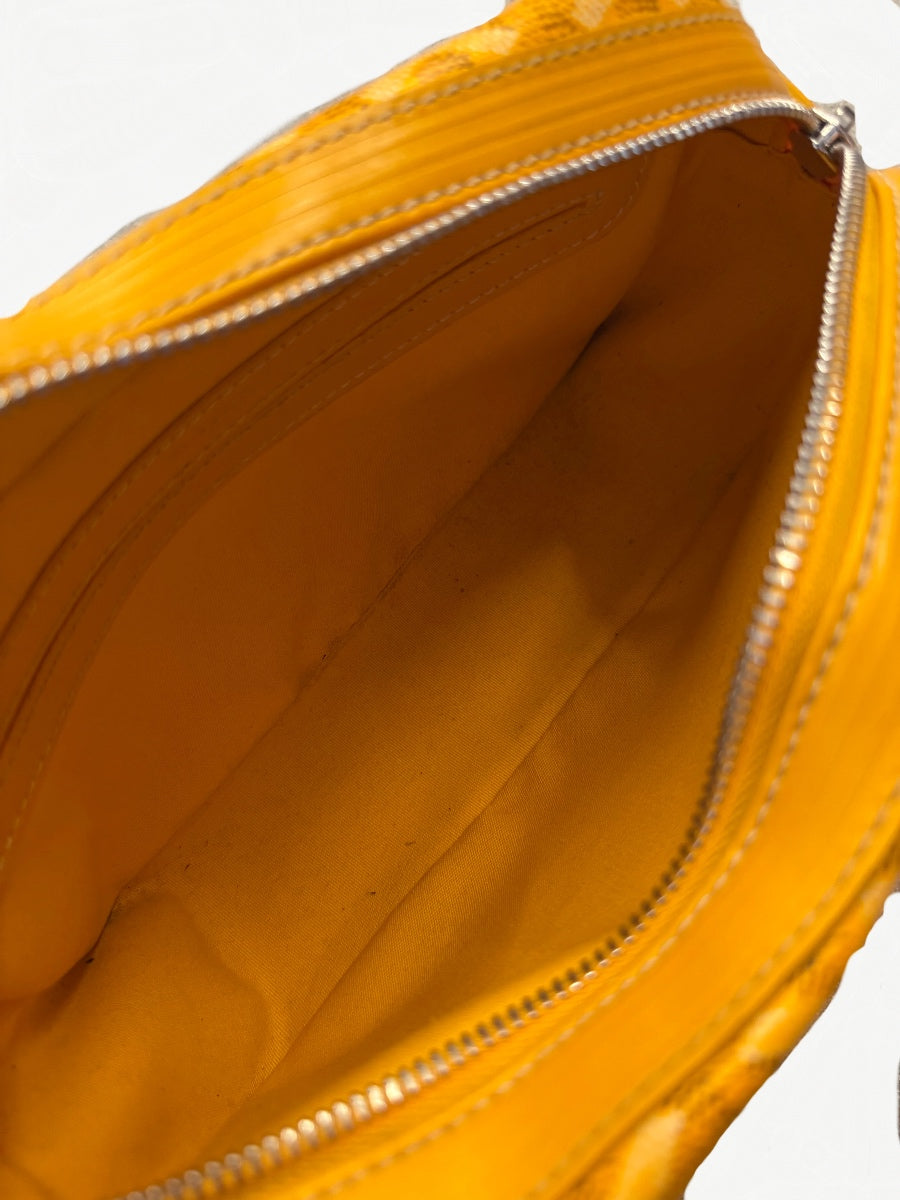 Interior view of Goyard yellow Cap Vert messenger bag showing bright yellow lining and zip pocket