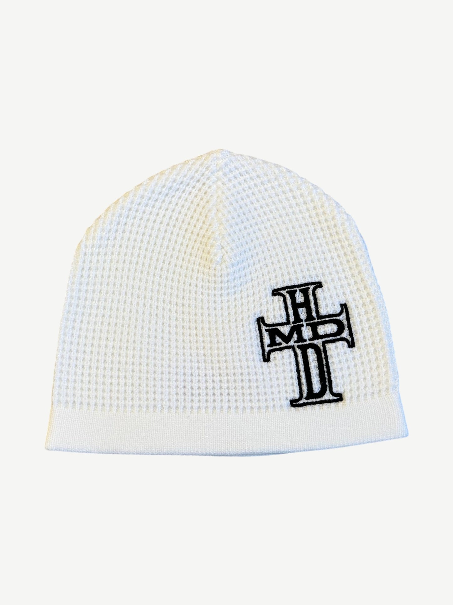 Happy Memories Dont Die cream waffle knit beanie with embroidered black HMDD holy cross logo on side.
