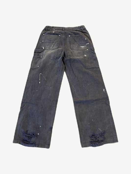 HMDD distressed carpenter pants rear view with utility pockets, paint splatter and shredded hem detail