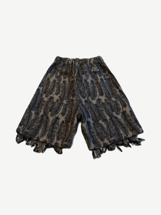 Kapital Magpie denim shorts back view with feather print pattern and wide raw fringed hem detail.