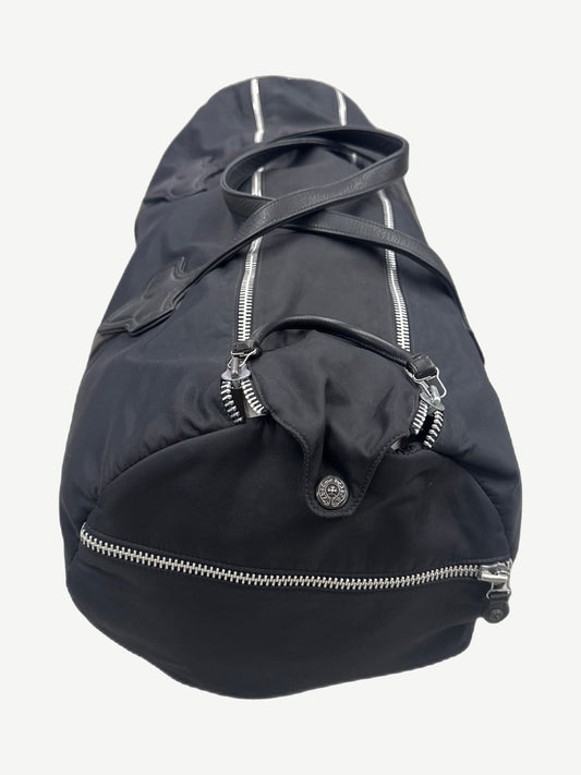 Chrome Hearts black nylon duffle end view showing cross button hardware and reinforced leather corner panel