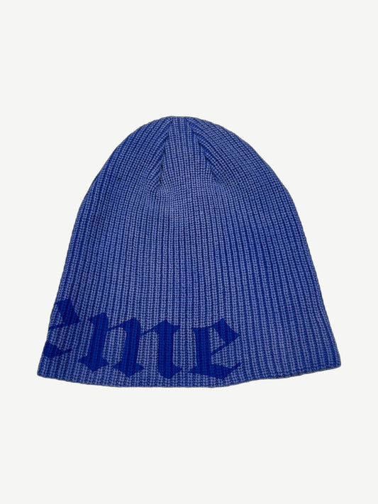 Supreme navy Old English printed beanie alternate angle showing folded cuff and woven brand logo tag
