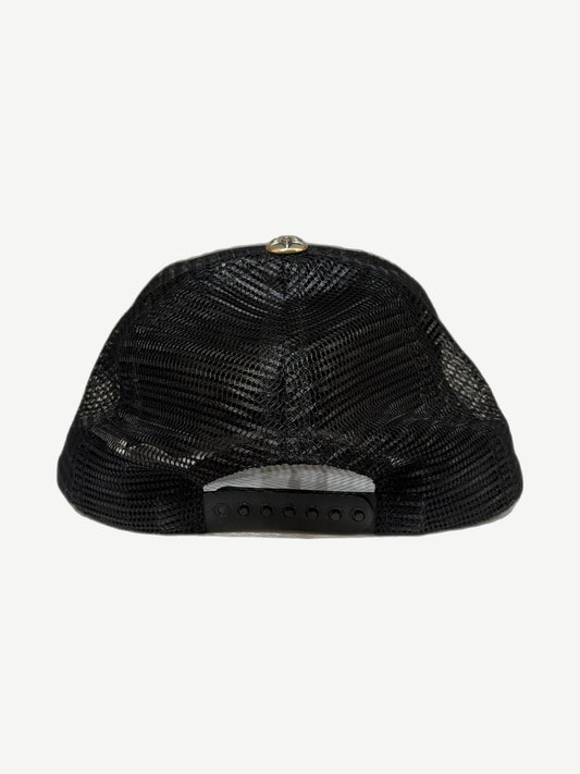 Chrome Hearts triple star trucker hat side profile showing curved brim and structured foam crown.