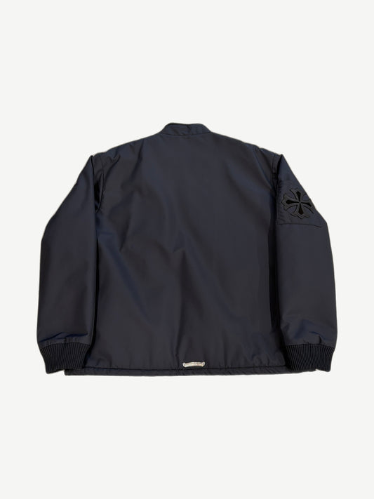Chrome Hearts black Cobra racing jacket back view with black leather cross patch on right sleeve