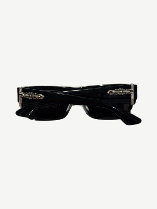 Chrome Hearts Yer Born Again sunglasses side angle showing silver cross dagger hinge hardware on black temple.