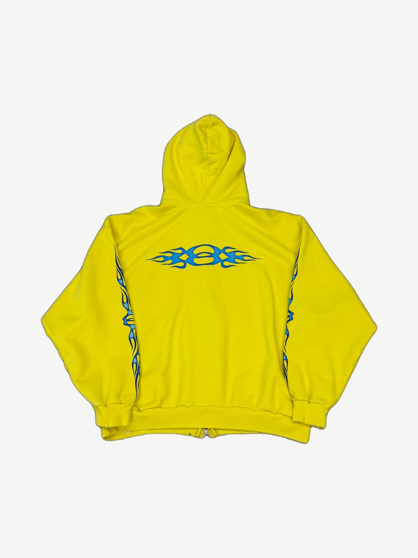 Balenciaga yellow Unity flame zip hoodie back, large blue tribal flame graphic across shoulders and sleeves.