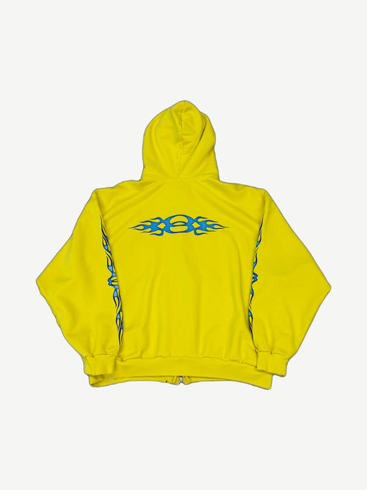 Balenciaga yellow Unity flame zip hoodie back, large blue tribal flame graphic across shoulders and sleeves.
