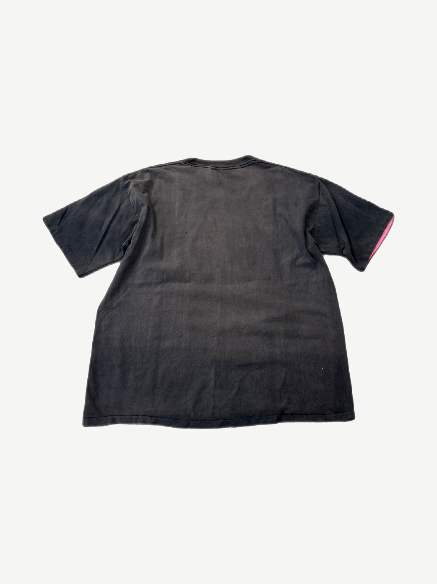 Back of vintage faded Harley Davidson Rose and Feathers tee showing sun-bleached black cotton blank.