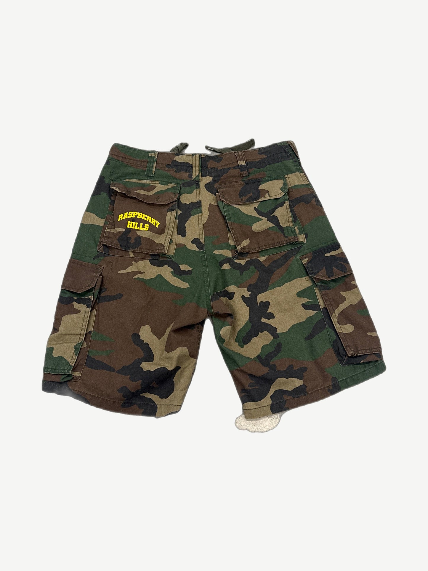 GV Gallery Raspberry Hills camo cargo shorts back with yellow logo on rear pocket, side cargo pockets.