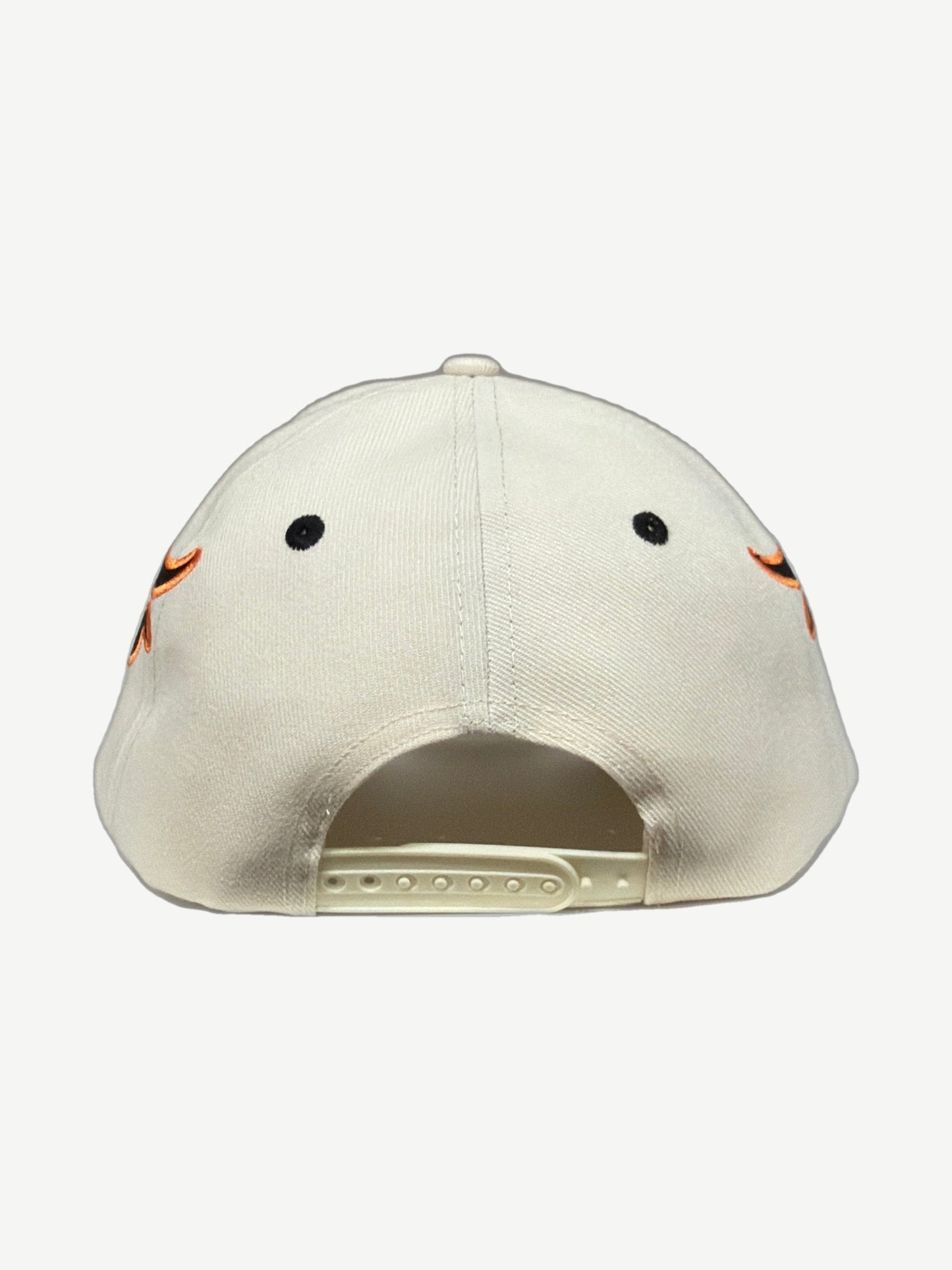 HMDD cream Memories snapback hat angled side view showing orange flame embroidery and curved brim.