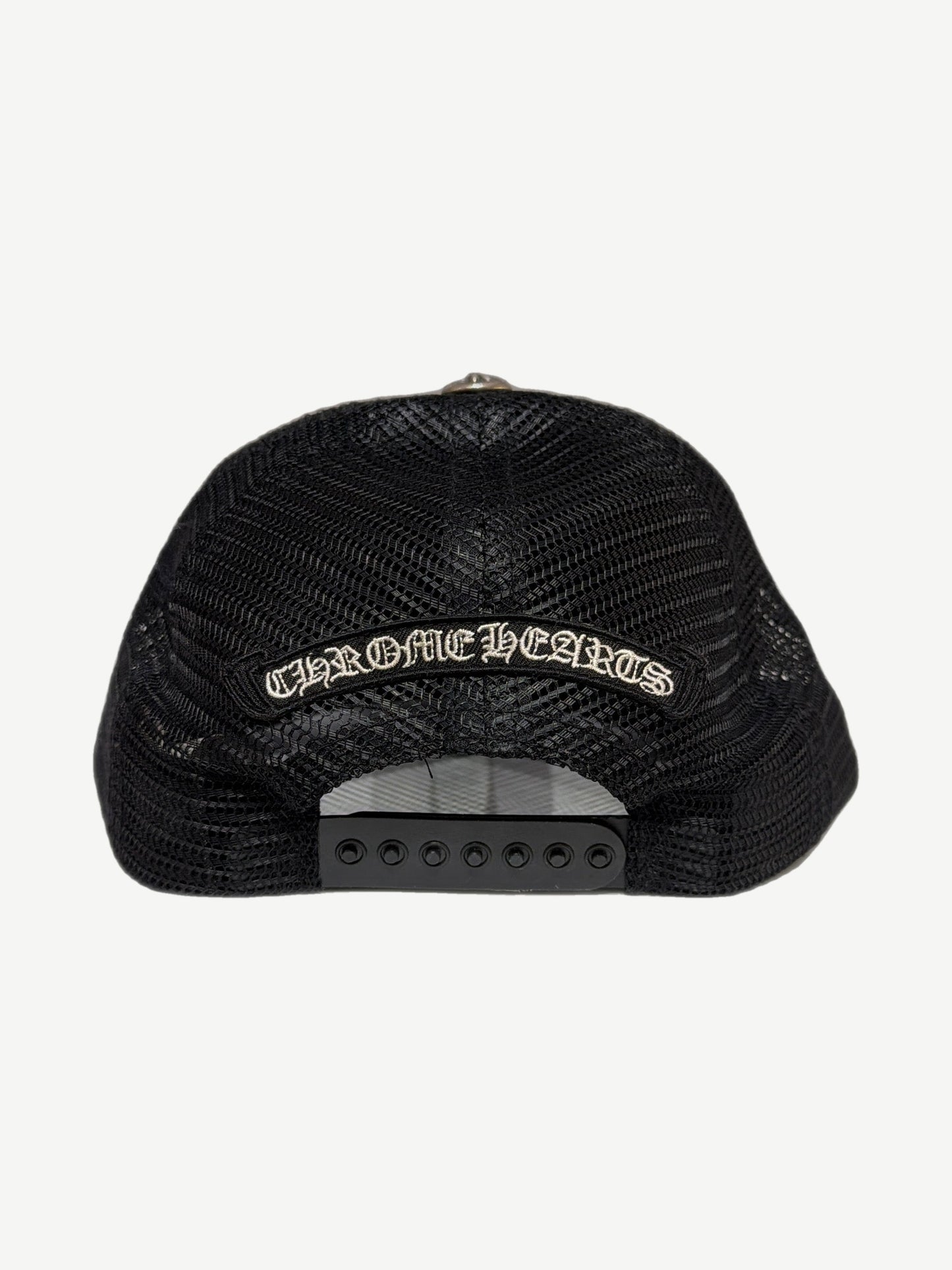 Chrome Hearts Cemetery trucker hat with multicolor cross patches scattered across black crown.