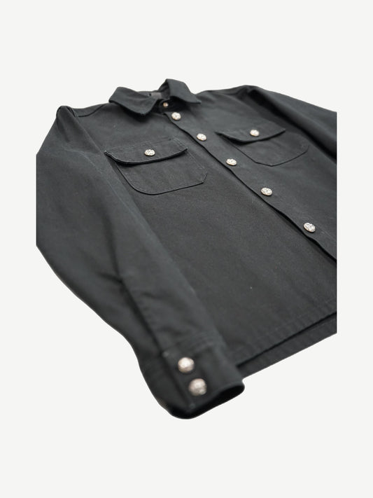 Chrome Hearts Work Dog jacket angled view showing black twill, dual chest pockets and silver cross snap buttons.