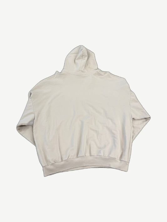 Balenciaga cream surfer logo hoodie back view with distressed hem edges and oversized boxy silhouette