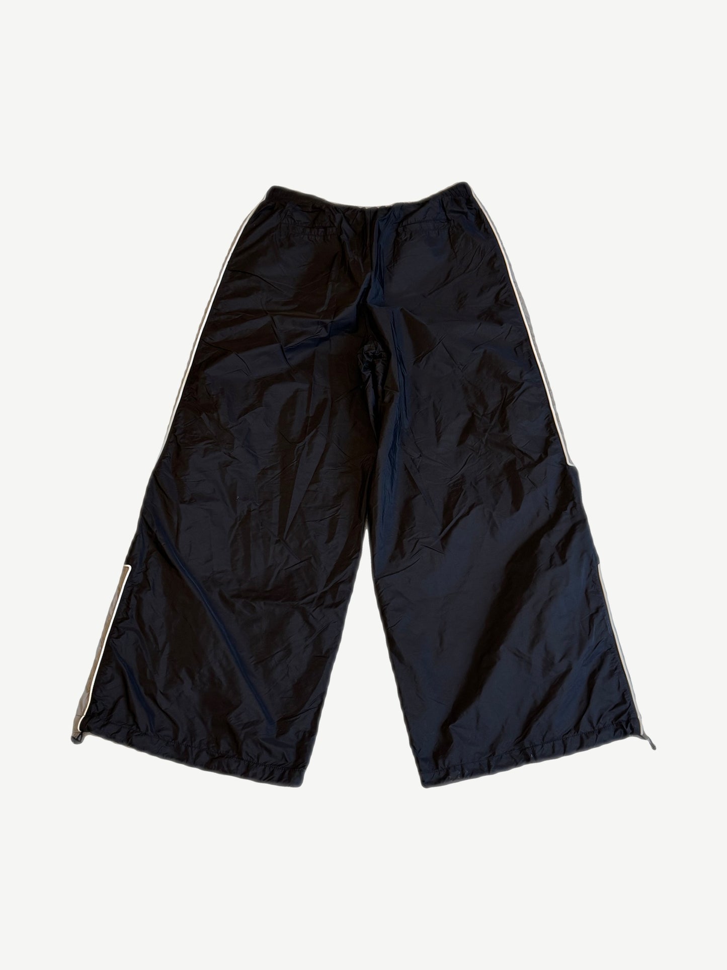 Happy Memories Don't Die HMDD black trackpants back view with white piping and zipped ankle gussets.