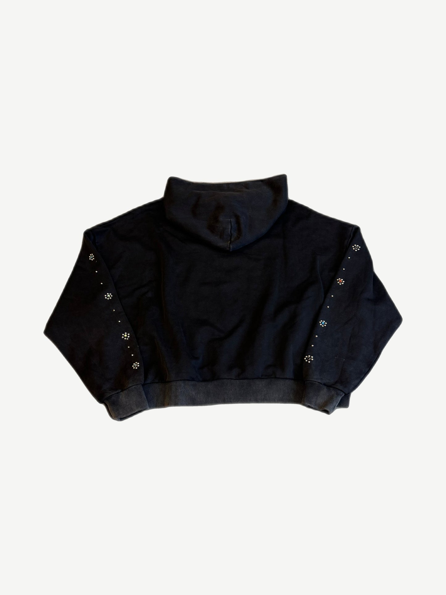 Back of HMDD Flower Studded black hoodie showing rhinestone flower embellishments scattered on sleeves.