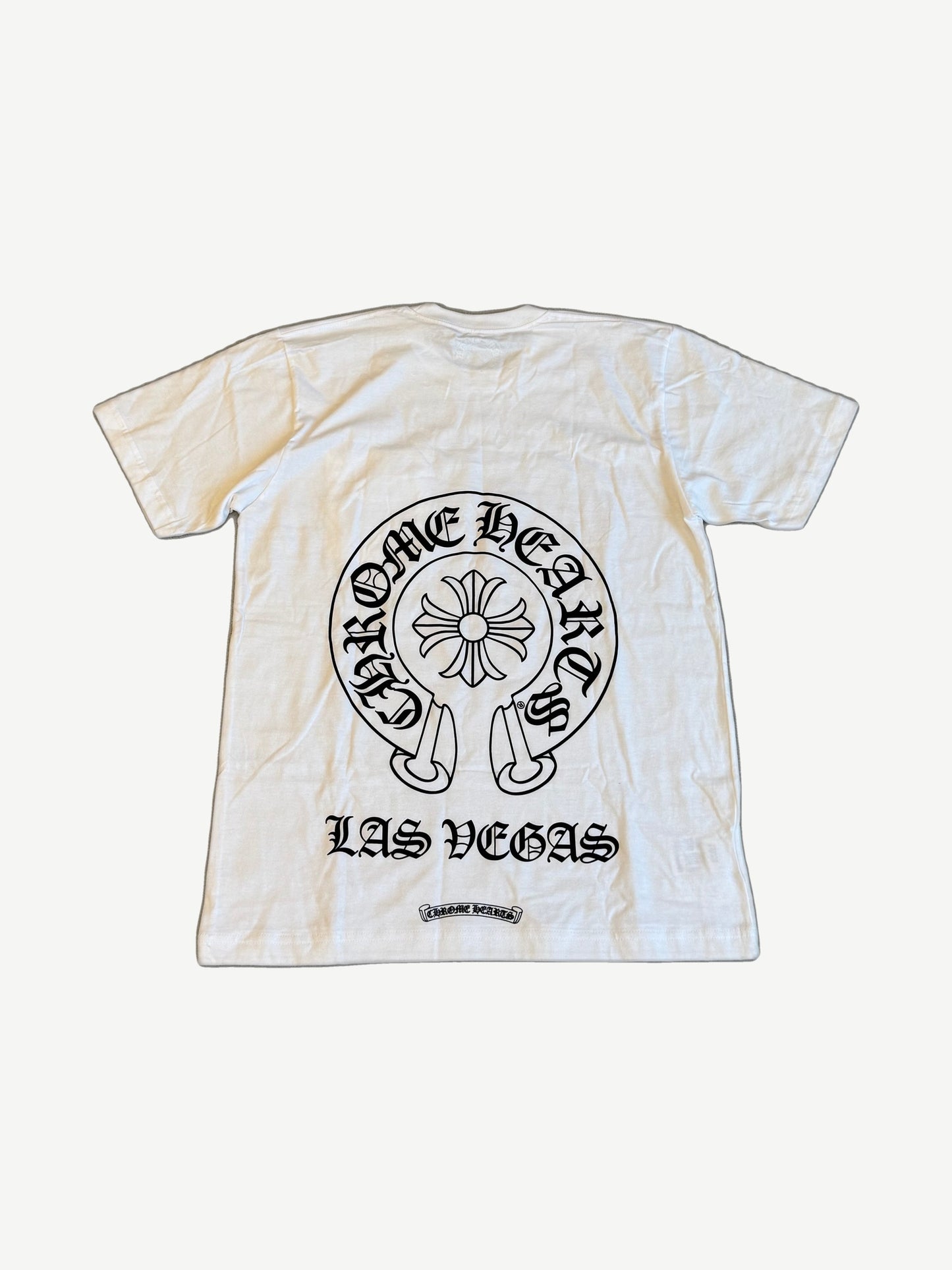Chrome Hearts white Las Vegas tee back with large gothic horseshoe cross and Las Vegas print