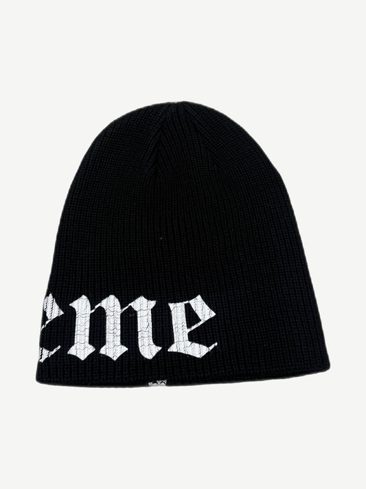 Supreme black beanie reverse side view showing tail of Old English Supreme script logo on the ribbed cuff