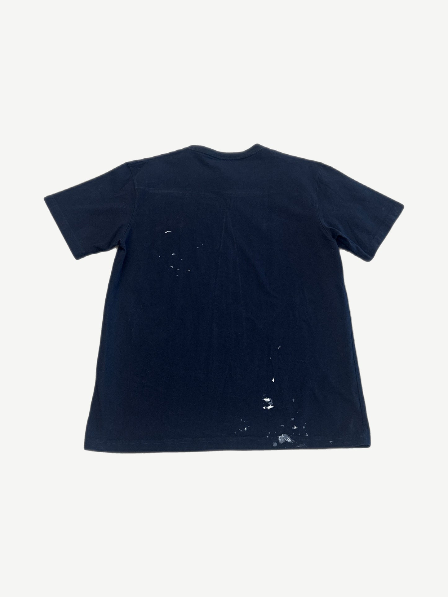 Dior x Cactus Jack navy oversized tee back view with white paint splatter detailing on lower hem
