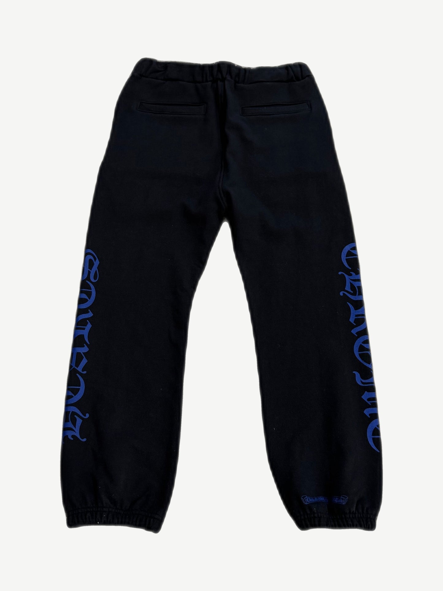 Chrome Hearts black sweatpants back view with blue gothic Chrome Hearts text down legs and welt back pockets
