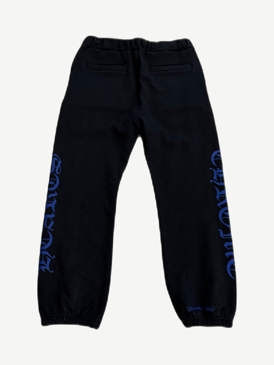 Chrome Hearts black sweatpants back view with blue gothic Chrome Hearts text down legs and welt back pockets