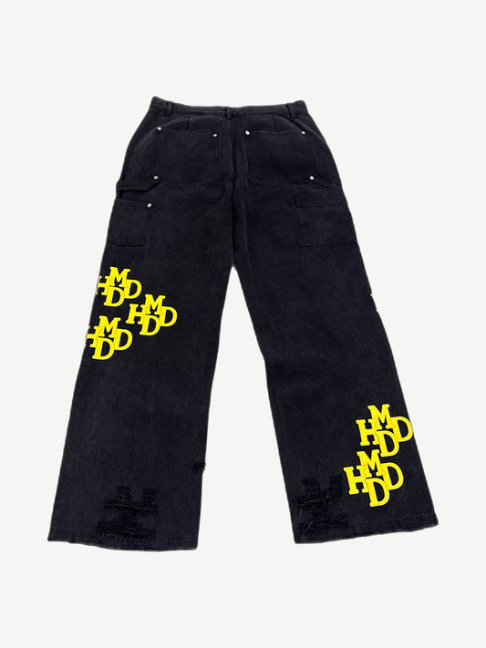 HMDD black carpenter pants back view with yellow contrast patches, hammer loop and double rear pockets