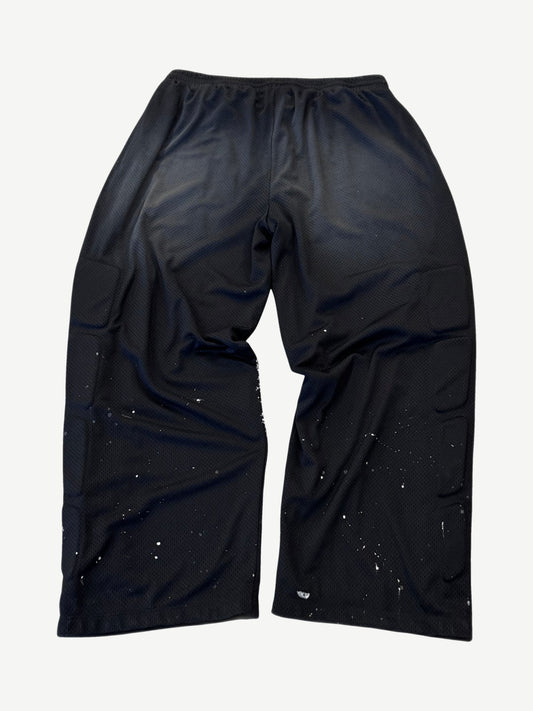 Satoshi Nakamoto black mesh moto sweatpants back view with side padding panels and paint splatter detail