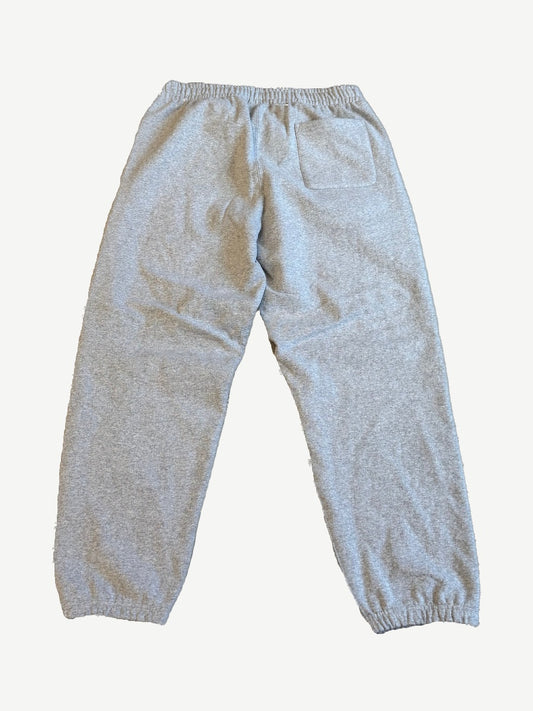 Back view of Supreme heather gray sweatpants with elastic waist, rear patch pocket and elasticated cuffs