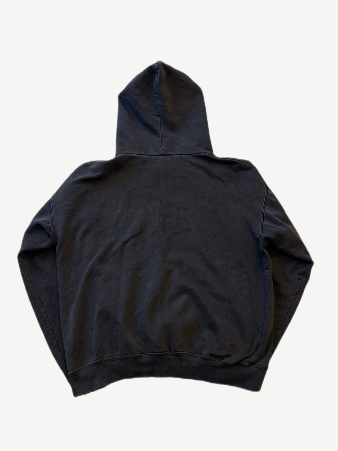 Back of vintage Misfits faded black hoodie showing blank distressed cotton fleece and hood drape