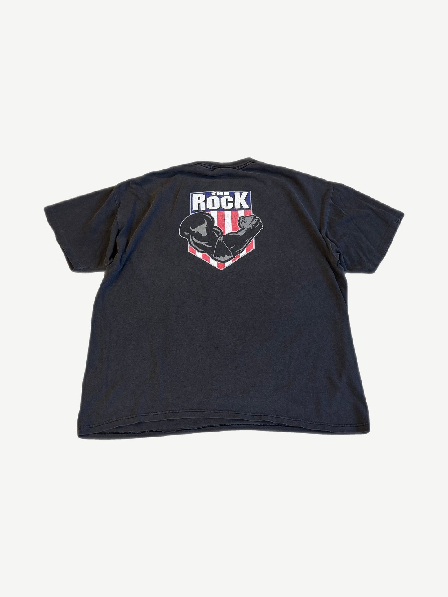 Vintage The Rock WWF tee back, faded black with red, white, blue THE ROCK flexing arm shield crest print.