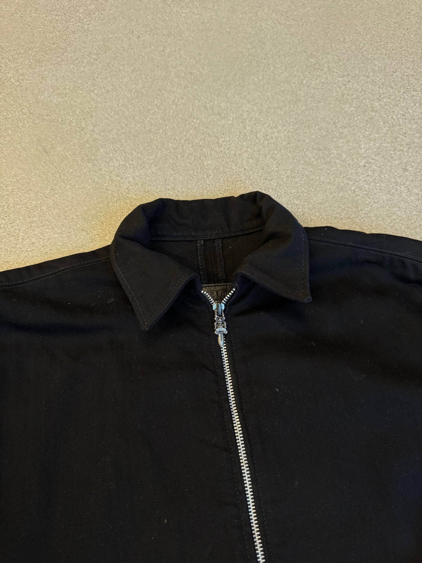 Chrome Hearts black jacket collar and zipper detail with two-way silver zip pull and point collar