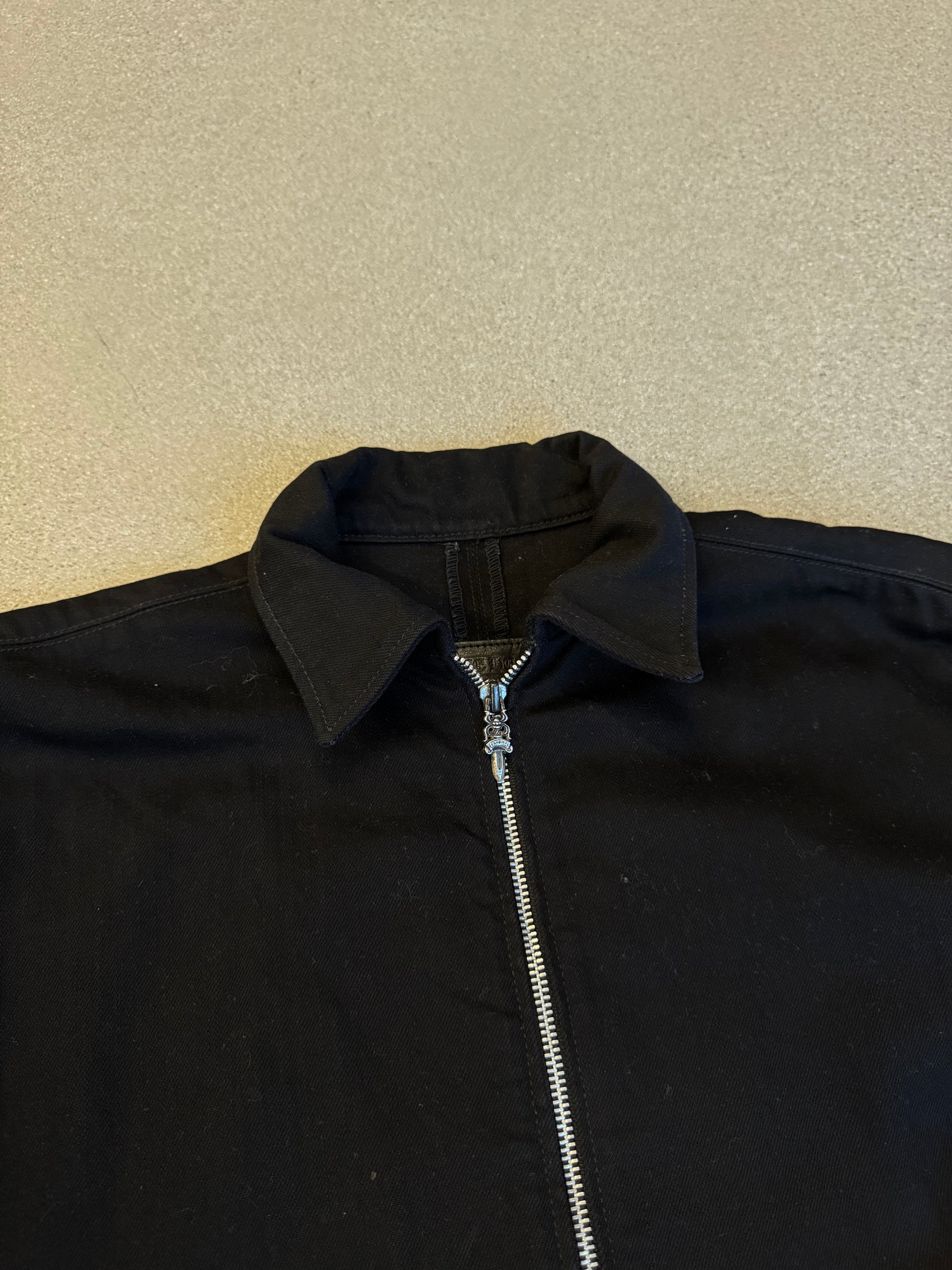 Chrome Hearts black jacket collar and zipper detail with two-way silver zip pull and point collar