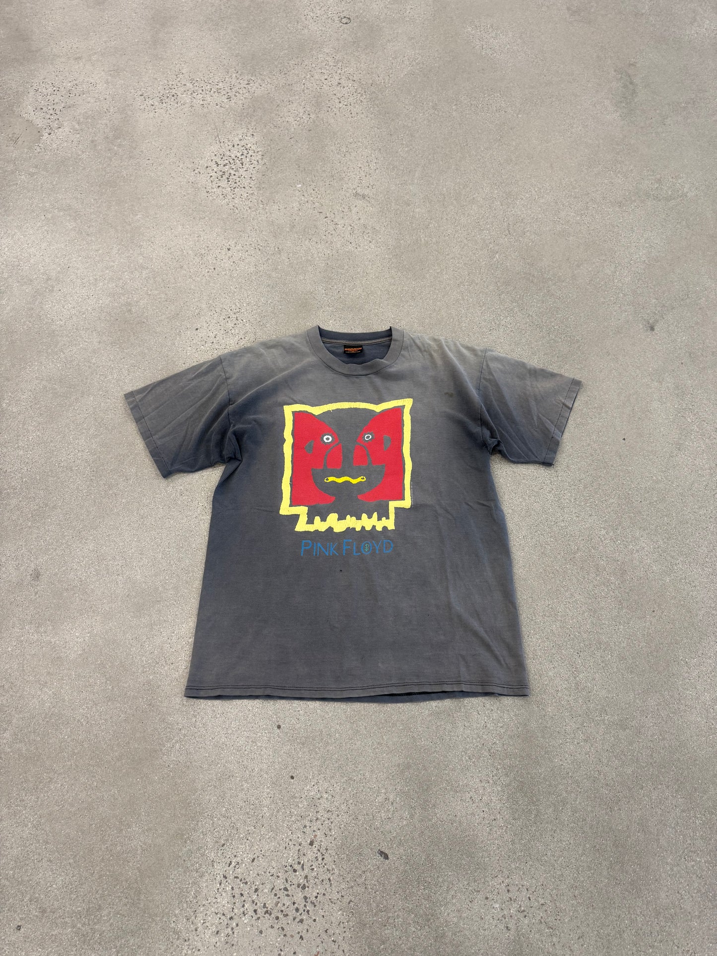 Pink Floyd Division Bell faded tee laid on concrete showing washed grey color and front face graphic
