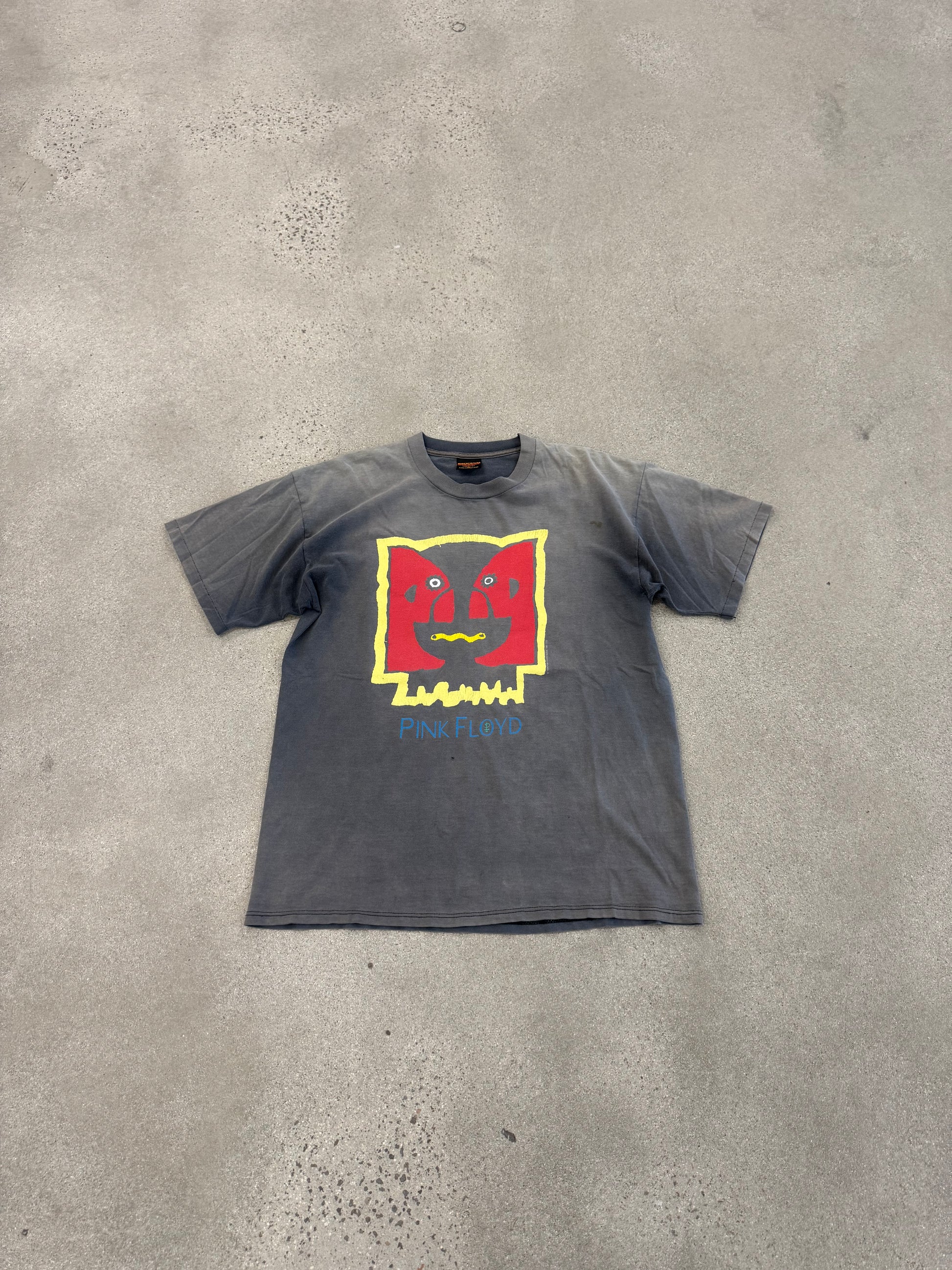 Pink Floyd Division Bell faded tee laid on concrete showing washed grey color and front face graphic