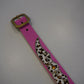 Vintage pink studded leather belt buckle detail, silver pyramid studs on animal print strap