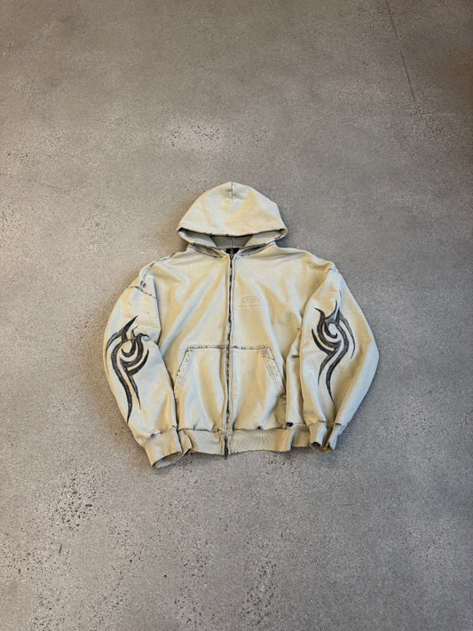 Balenciaga cream hooded zipup with black tribal flame graphics on sleeves and distressed sun-faded finish